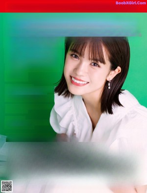 A woman in a white blouse posing for a picture.