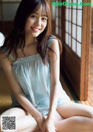 A woman laying on top of a wooden table.