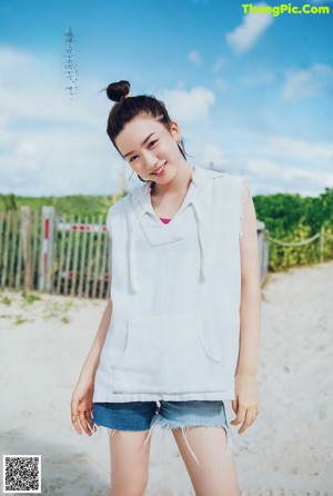 A woman in a pink dress posing for a magazine.