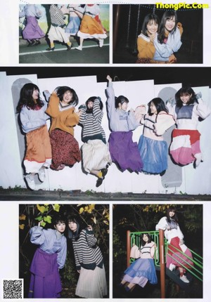A group of young women posing for a photo in front of a wall.
