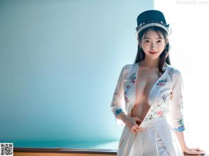 A woman in a red and white hanbok poses for a picture.