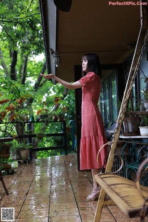 A naked asian woman posing on a wooden table.