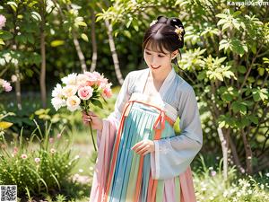 A woman in a purple and white kimono posing for a picture.