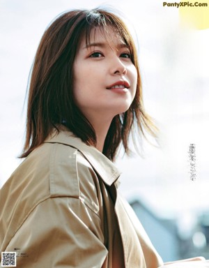A woman in a blue coat is featured in a magazine.