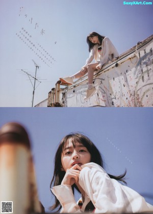 A woman standing on top of a roof next to a building.