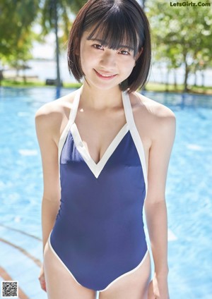 A woman in a bikini standing on a beach.